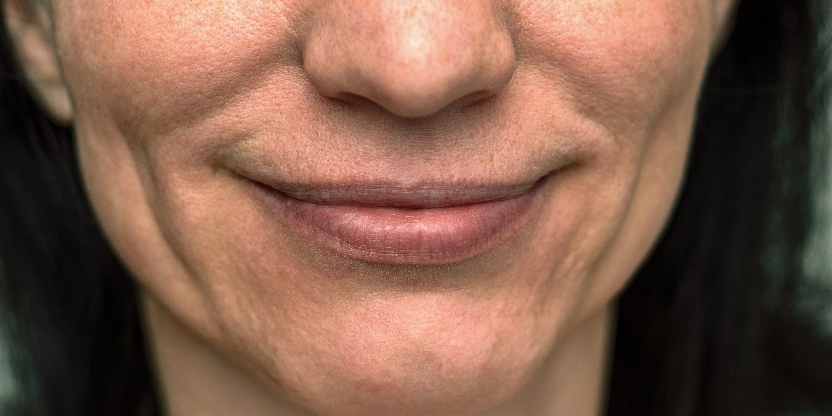 Close up on the smiling mouth of a young woman